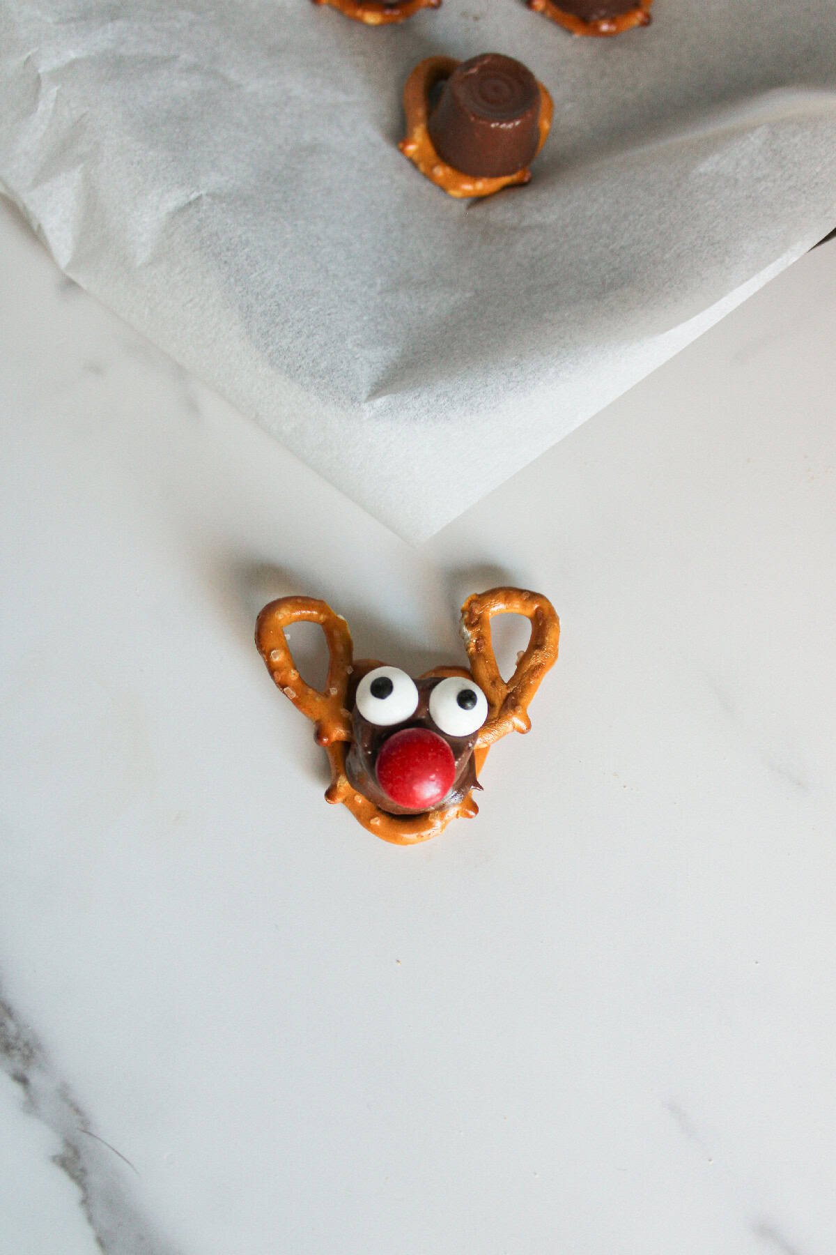 A red candy piece pressed onto the front of the Rolo chocolate to create Rudolph's signature red nose.