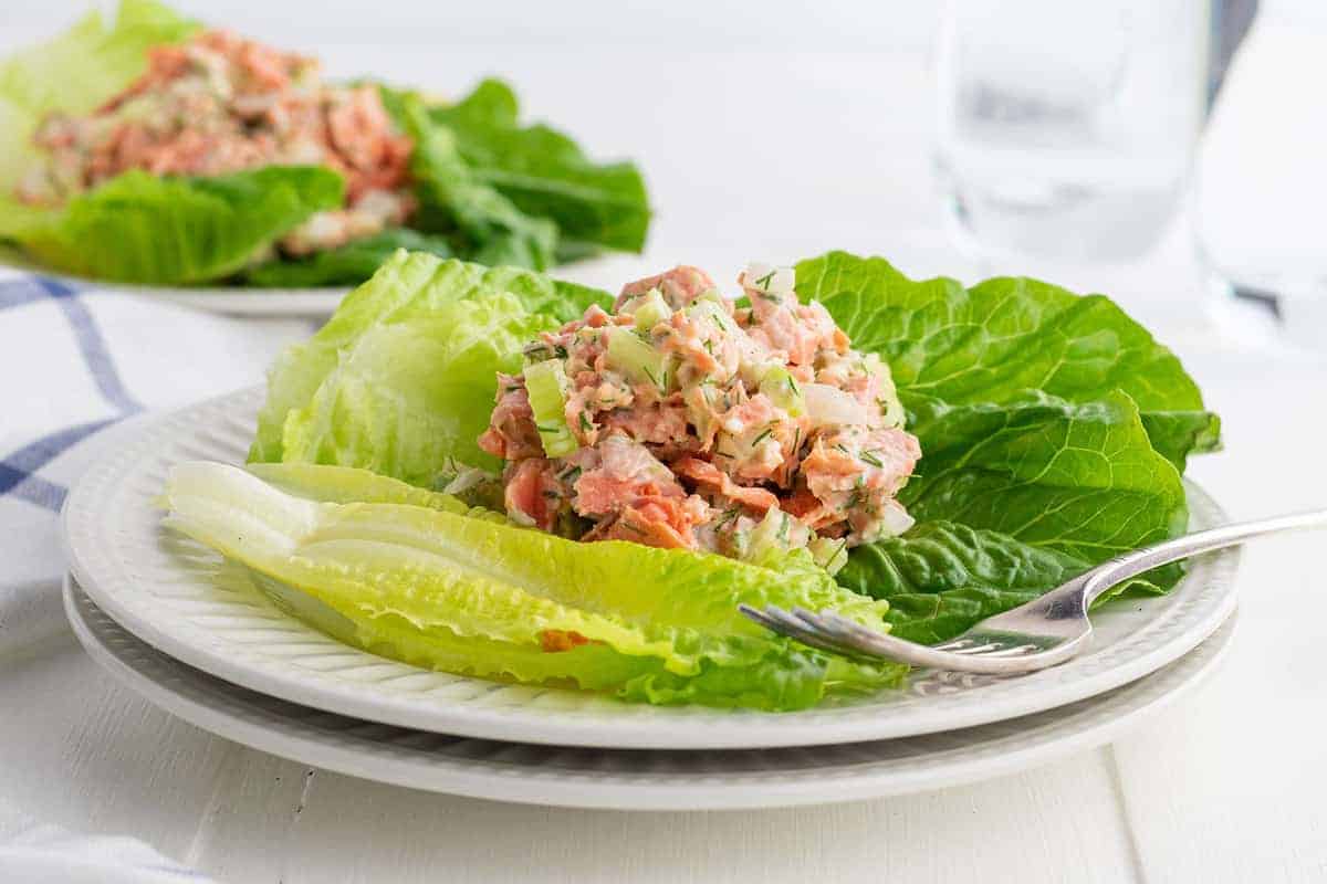 Salmon salad on greens with lemon.