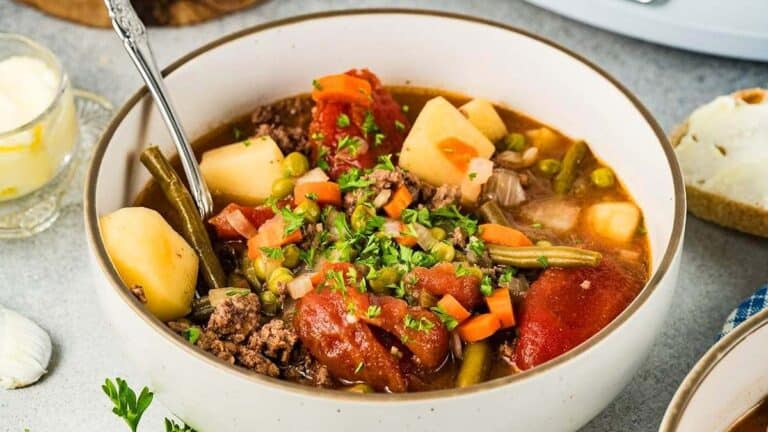 Bowl of hearty beef and vegetable stew made in a slow cooker.