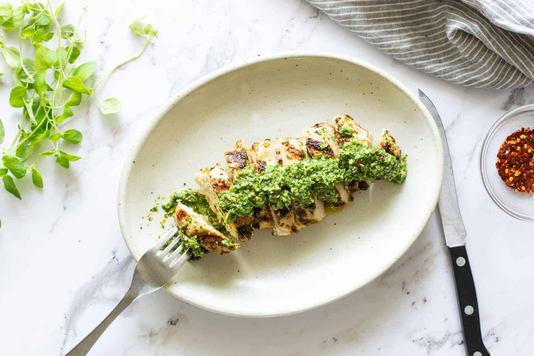 Grilled chicken topped with fresh chimichurri sauce.