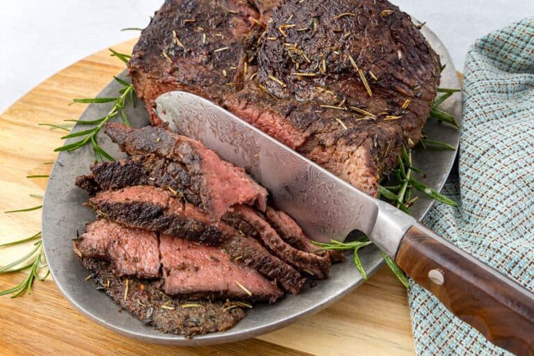Sliced Herb Crusted Beef Sirloin Tip Roast on a plate.
