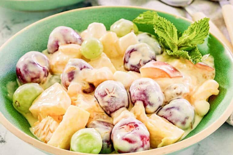 Chilled fruit salad mixed with a sweet creamy dressing.