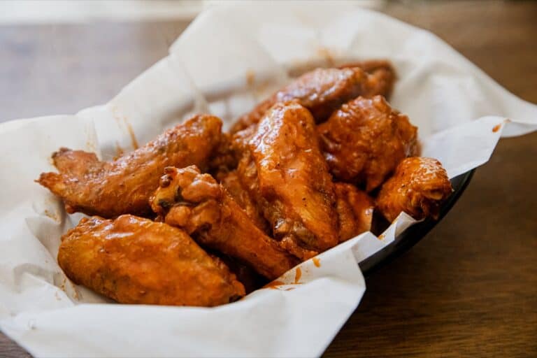 Air-fried chicken wings coated in spicy buffalo sauce.