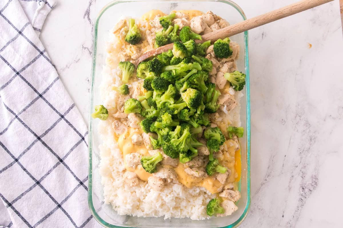 Cooked chicken added on top of the creamy rice mixture for baked chicken broccoli rice casserole.