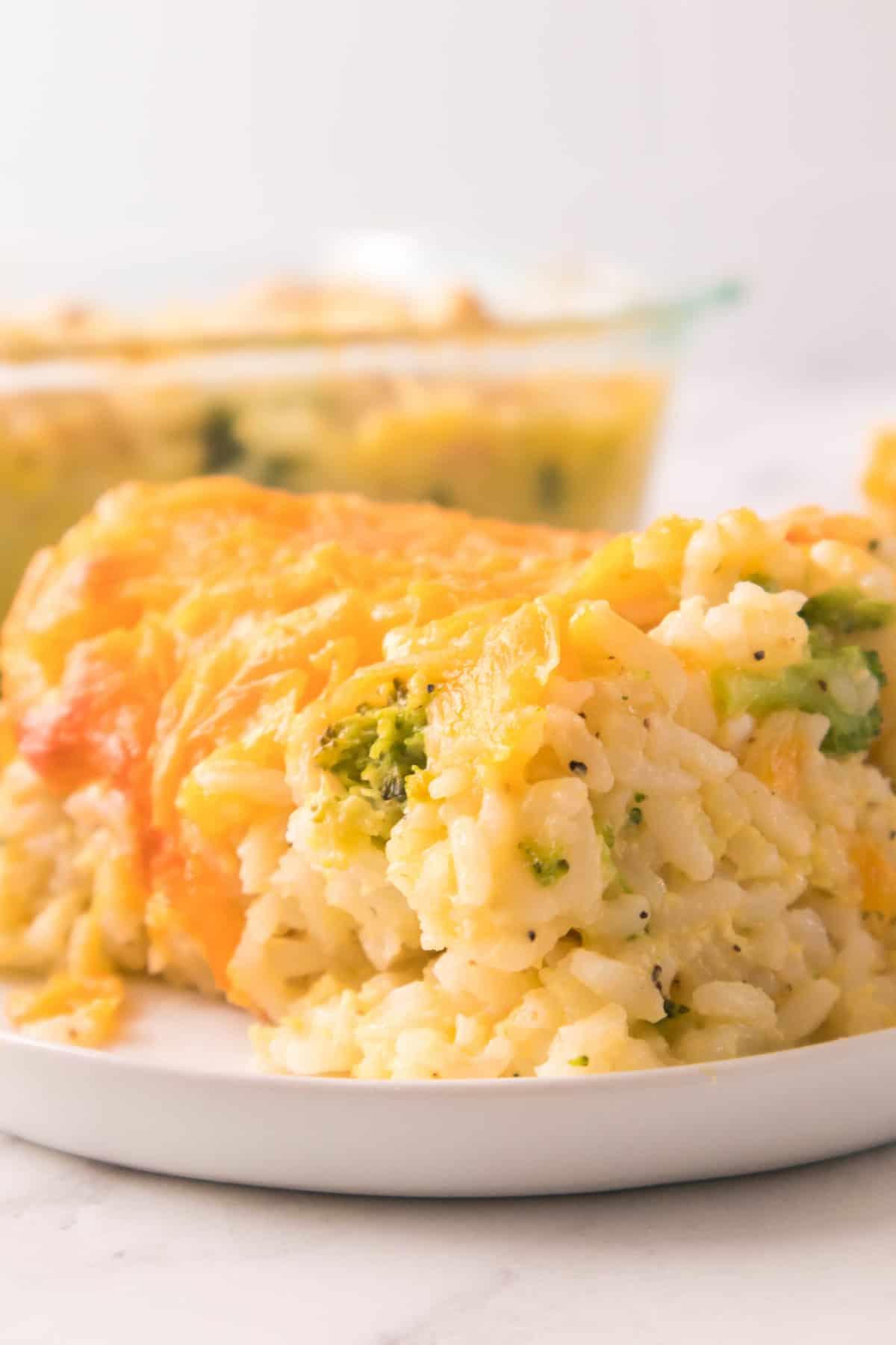 Chicken broccoli rice bake with gooey cheddar cheese and tender broccoli up close.