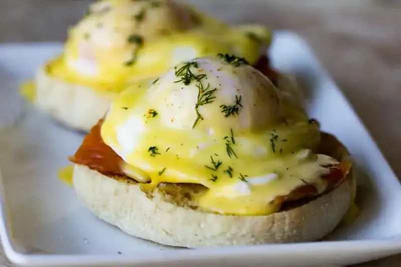 Poached eggs served on English muffins with hollandaise.