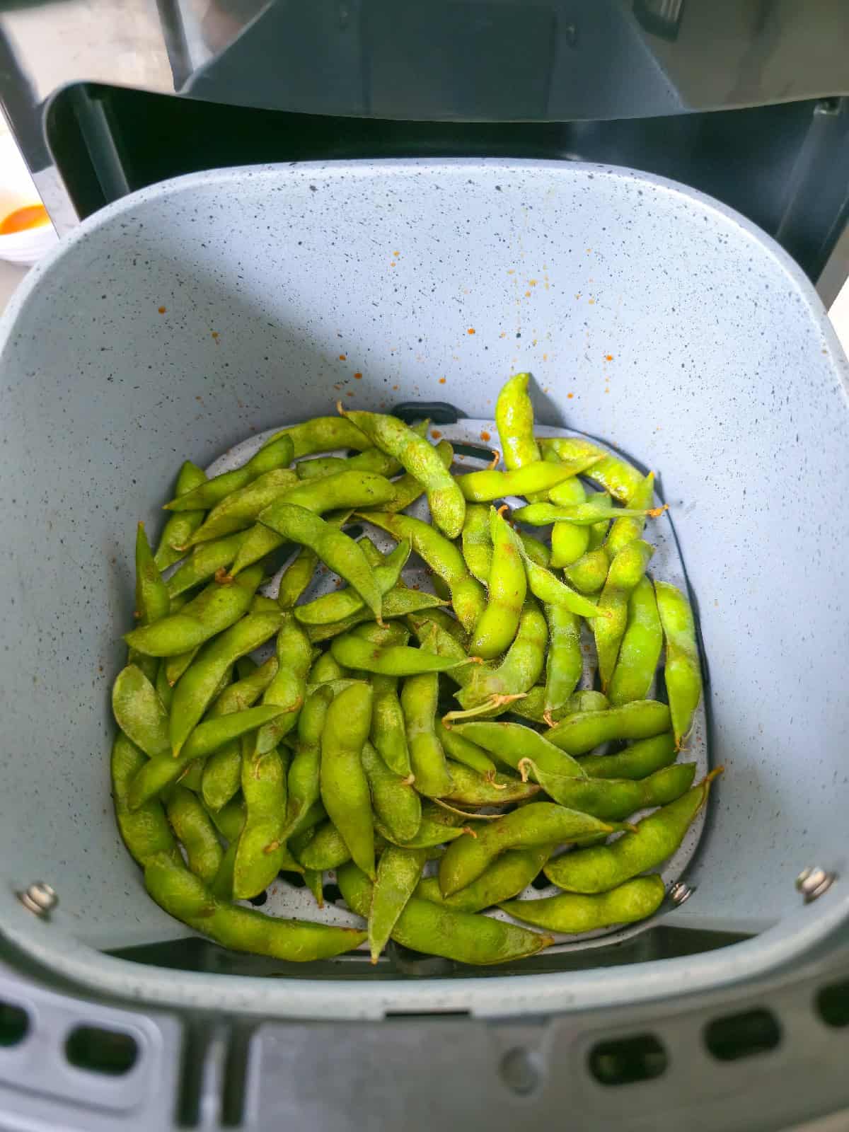 Air fryer edamame cooked until tender and lightly seasoned.
