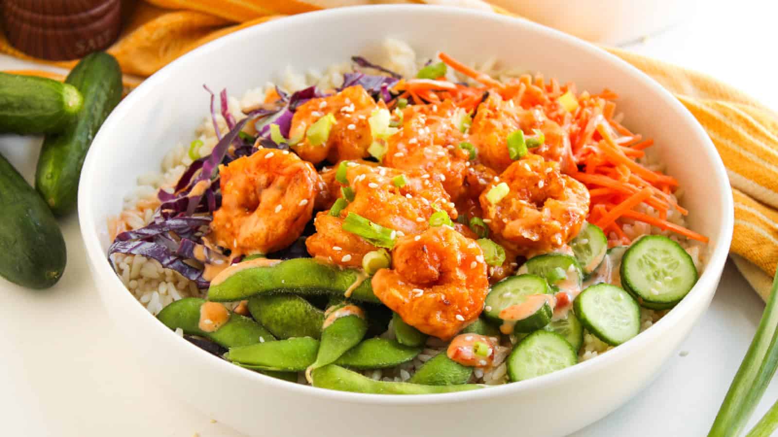 Finished bang bang shrimp bowl served with rice, vegetables, and sauce.