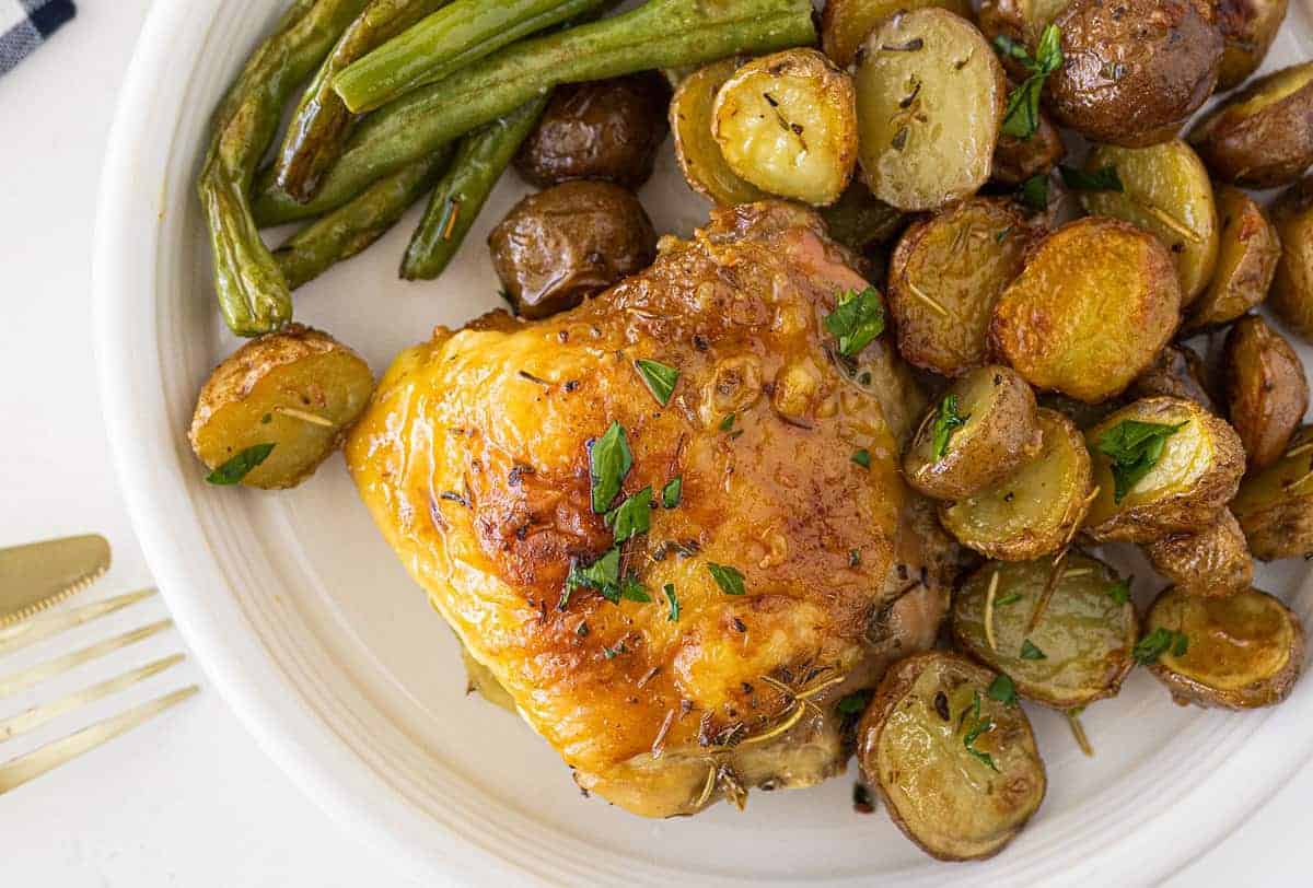 Chicken and potatoes baked in a buttery garlic herb sauce.