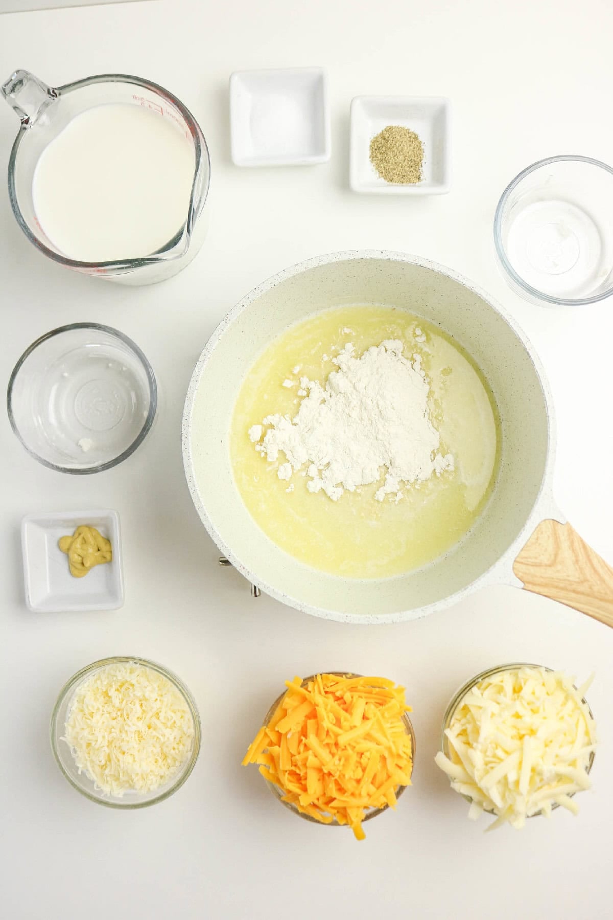 Flour added to melted butter in a saucepan to make a roux for cheese sauce.