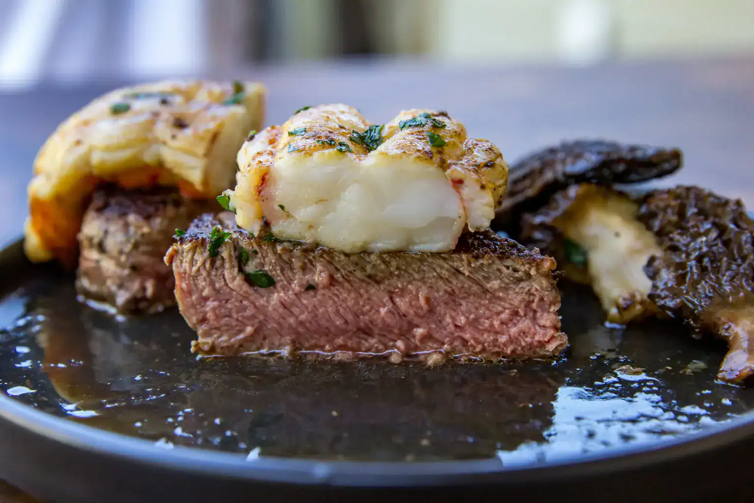 Filet mignon served with lobster tail, grilled on a Blackstone.