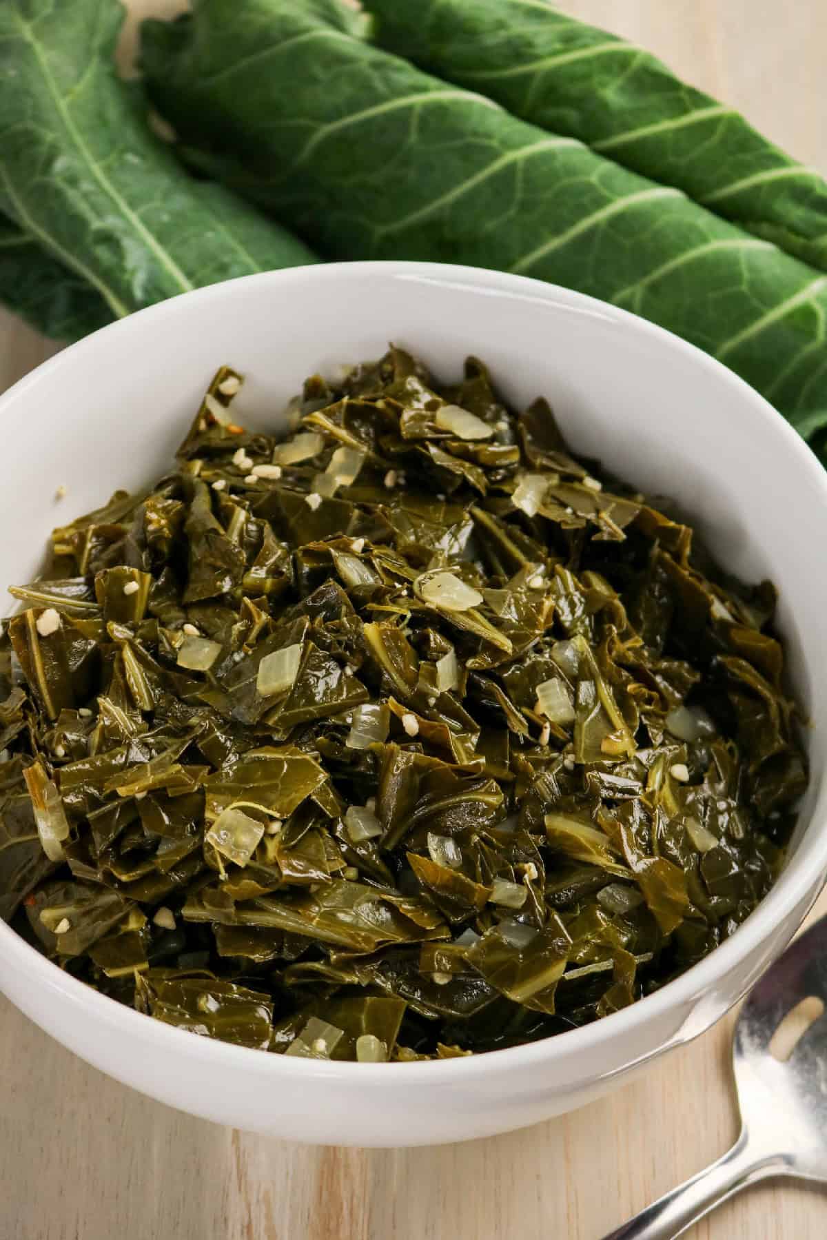 Bowl of braised collard greens served as a savory side dish.