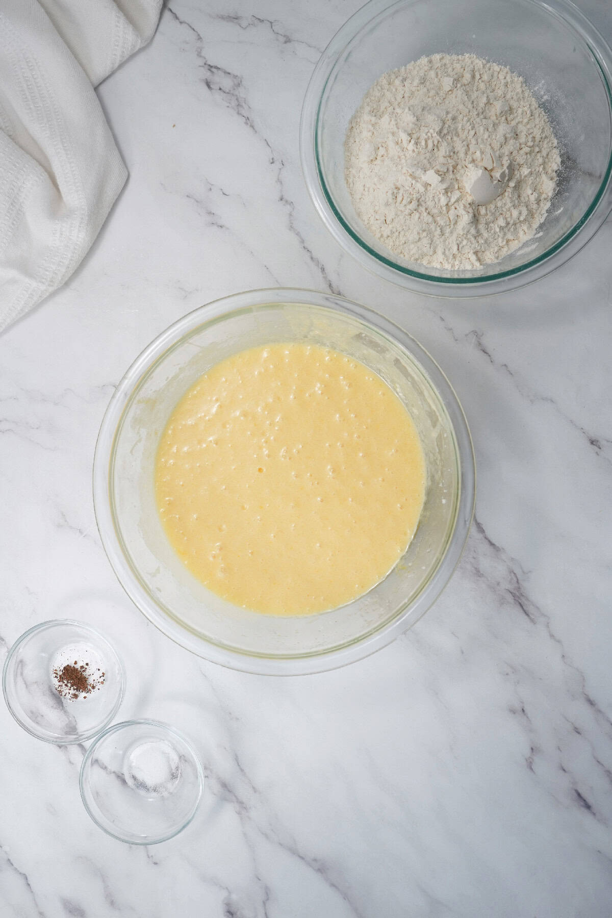 Wet ingredients mixed together in a glass bowl for Easter bundt cake batter.