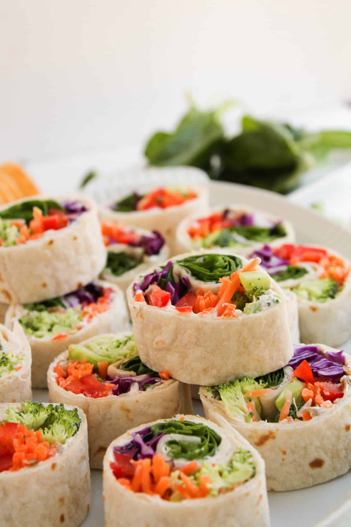 Colorful vegetable pinwheels arranged for serving at a party or snack table.