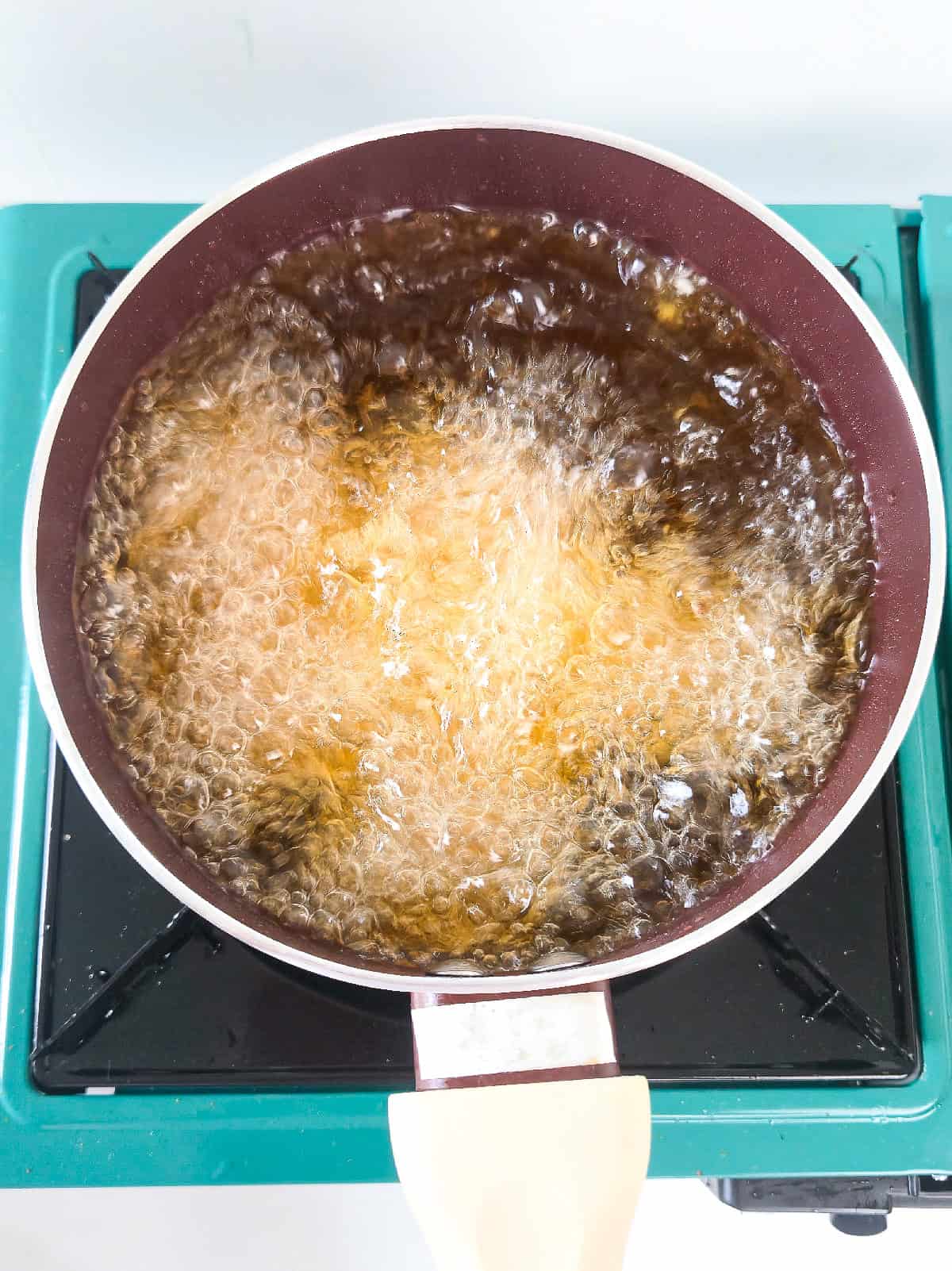 Frying tofu in hot oil until golden and crispy.