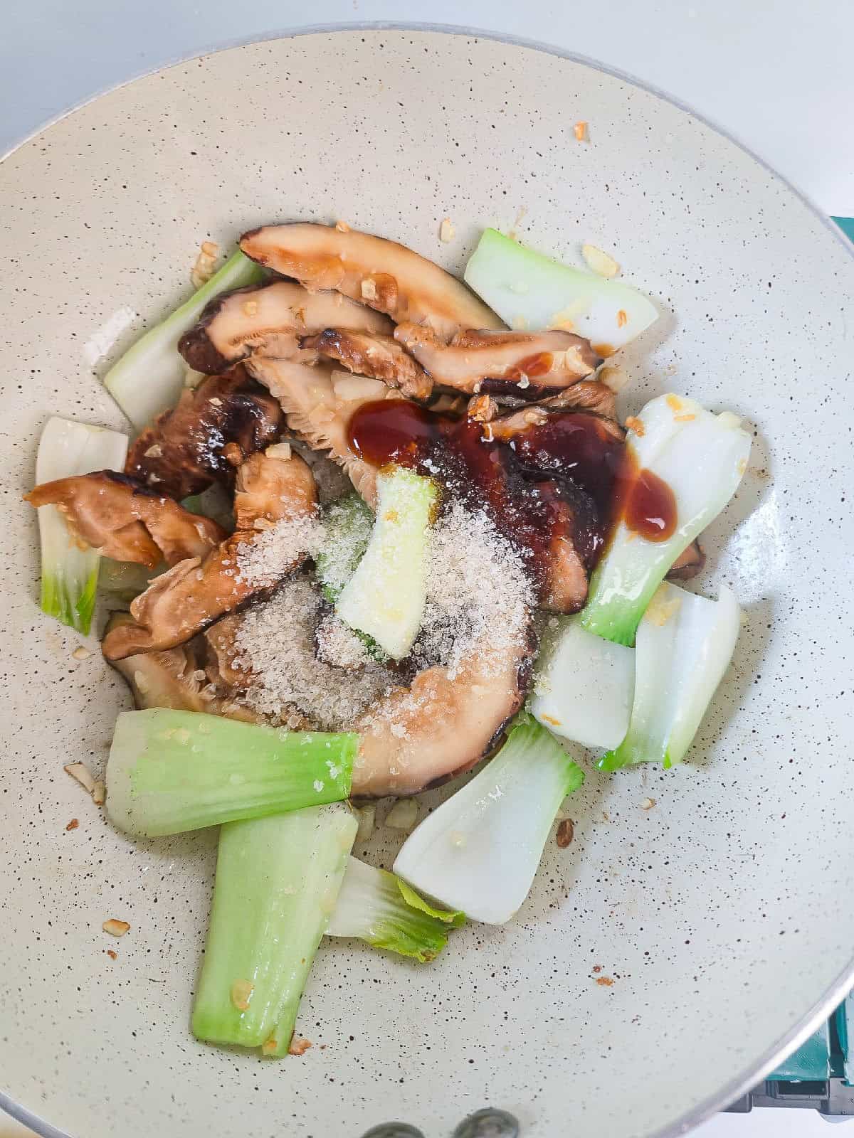 Stir-fry sauce poured over bok choy and mushrooms.