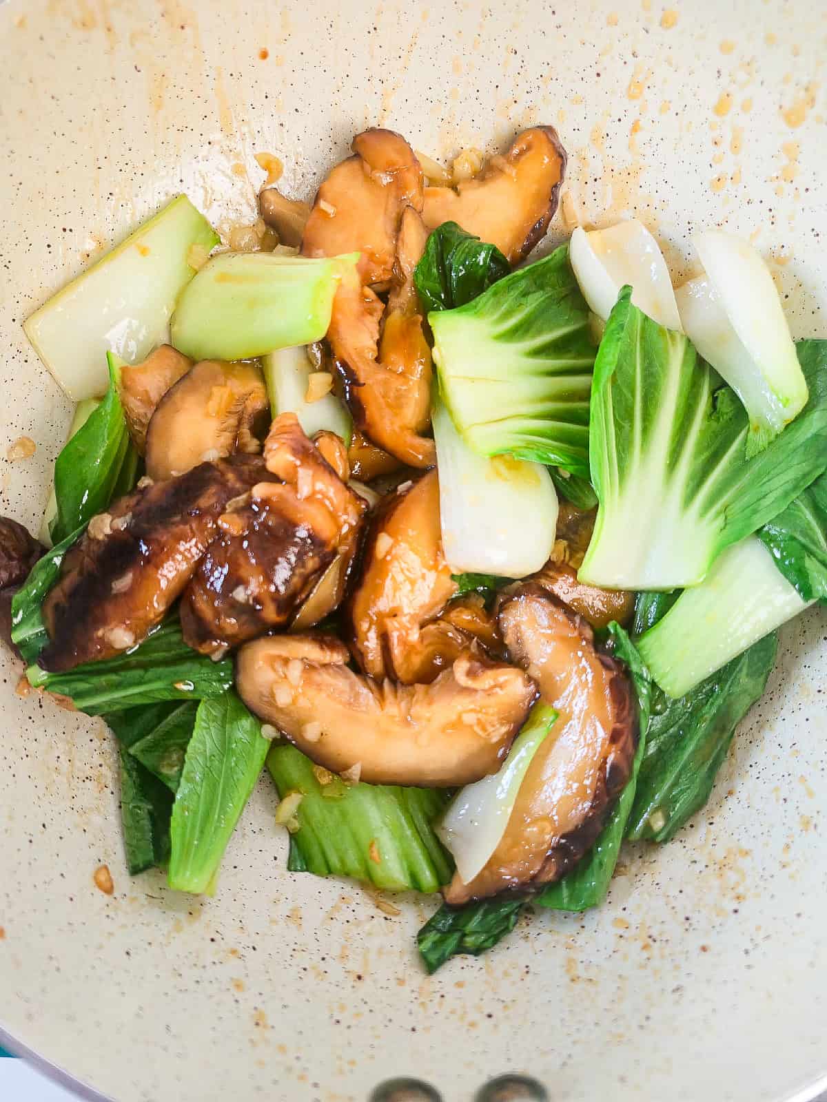 Finished bok choy and shiitake mushroom stir-fry in a skillet.