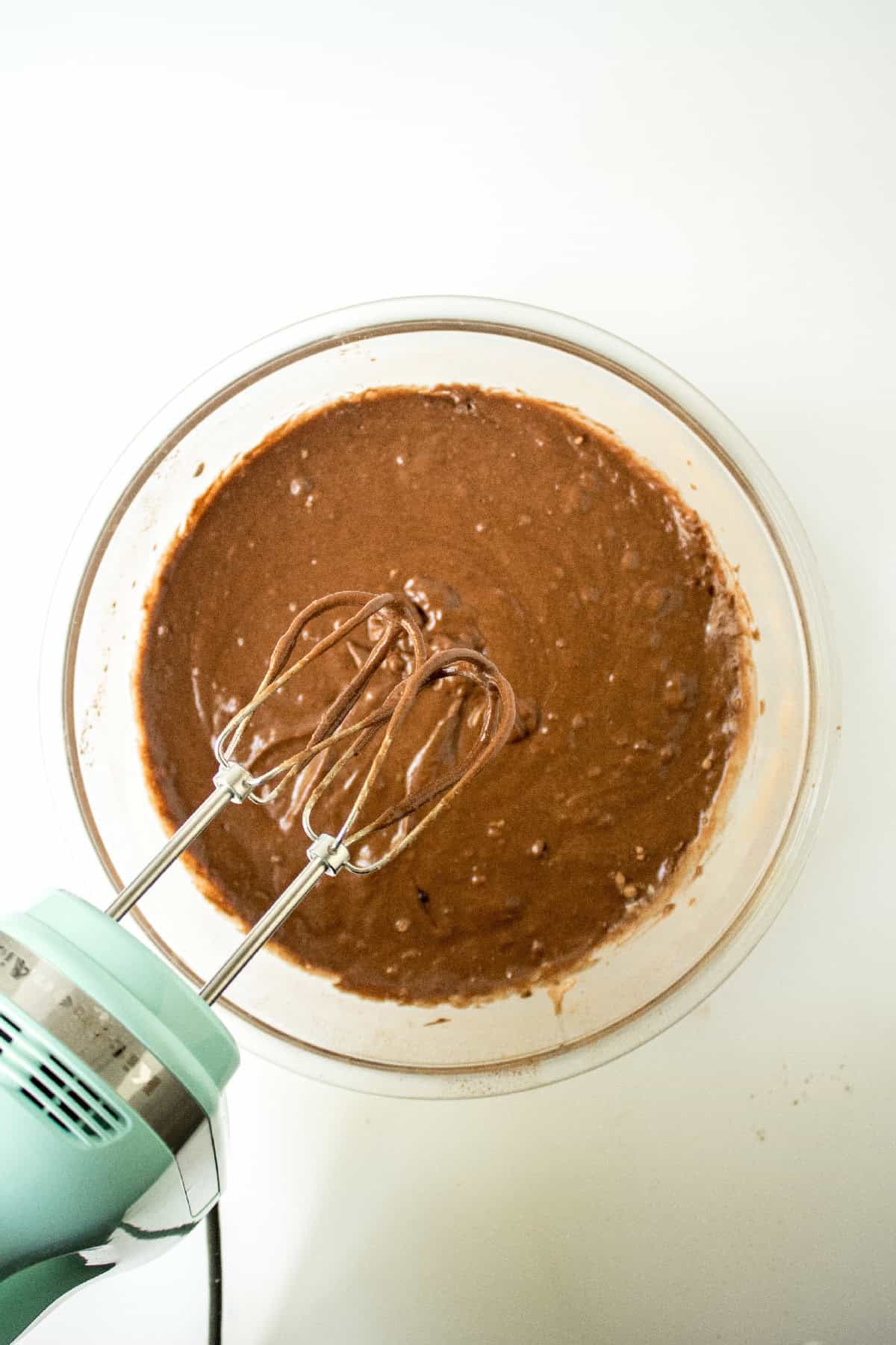 Eggs and liquid ingredients added to the center of dry chocolate cake batter before mixing.