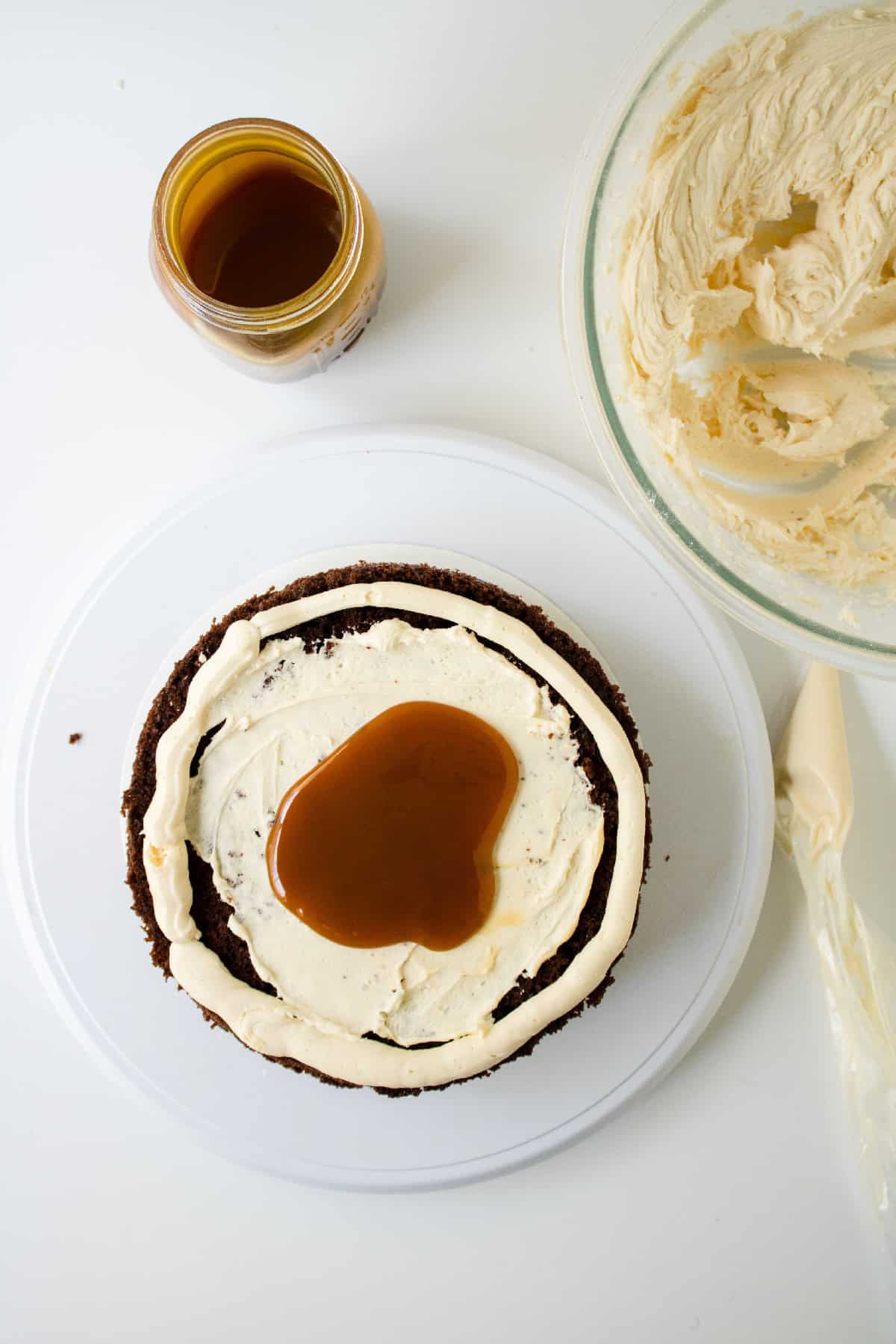 Buttercream frosting added on top of caramel filling before stacking the cake layers.