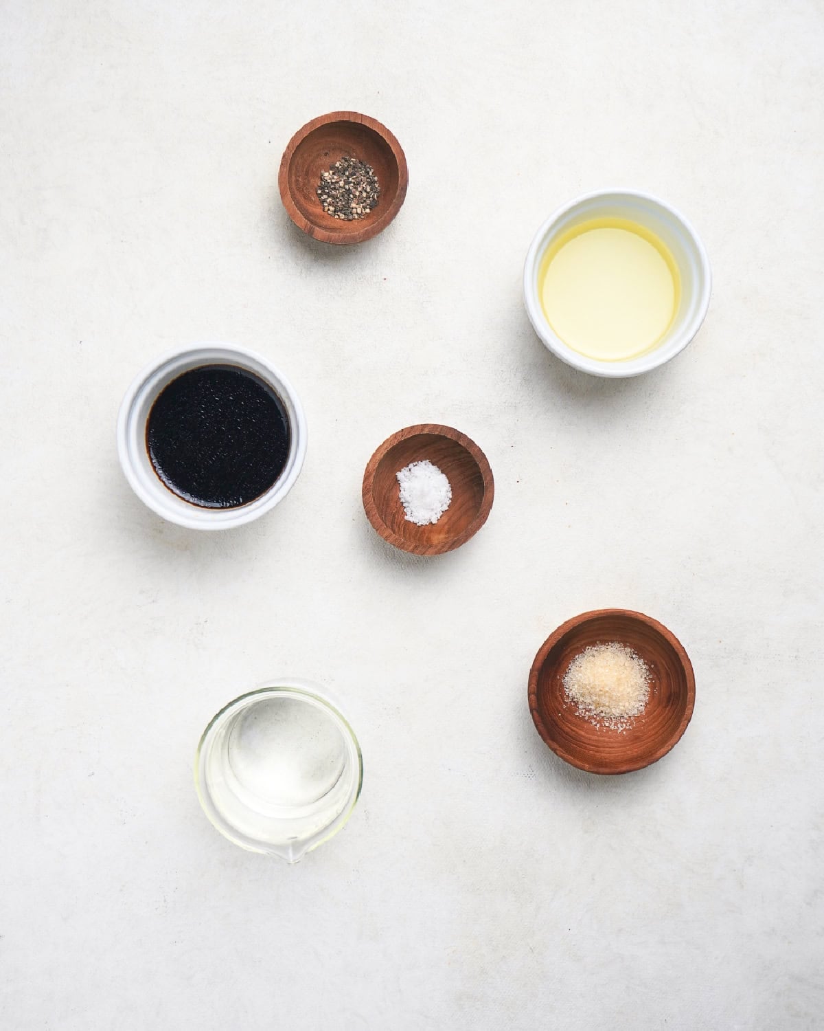 Soy sauce, oil, salt, sugar, black pepper, and water for Chinese steamed bass sauce.