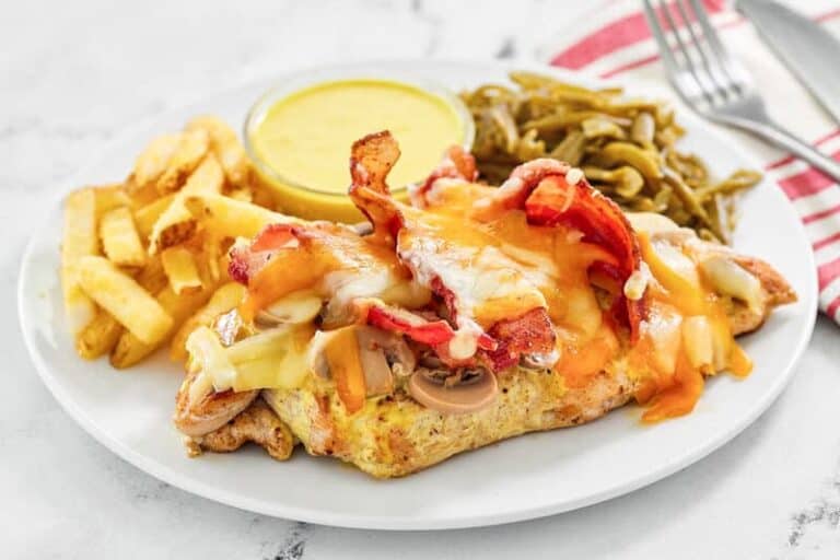 Grilled chicken topped with bacon, mushrooms, and cheese.