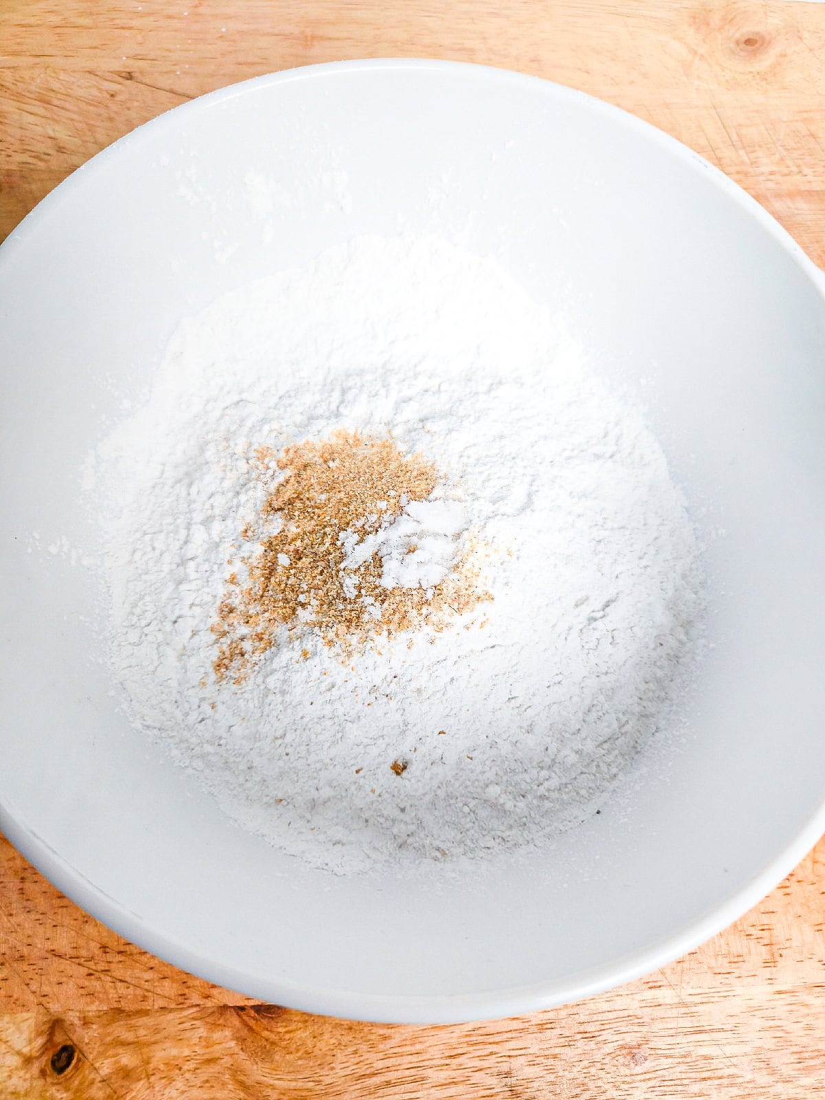 Cornstarch and seasonings mixed together in a bowl for coating oyster mushrooms.
