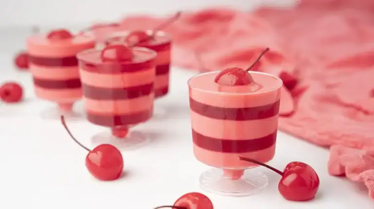 Cherries and Cream Layered Jello Shots on a white table.