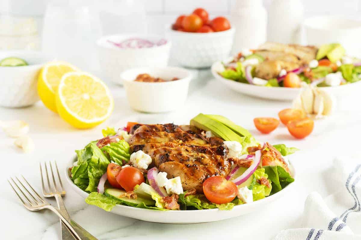 Grilled chicken over a fresh green salad.