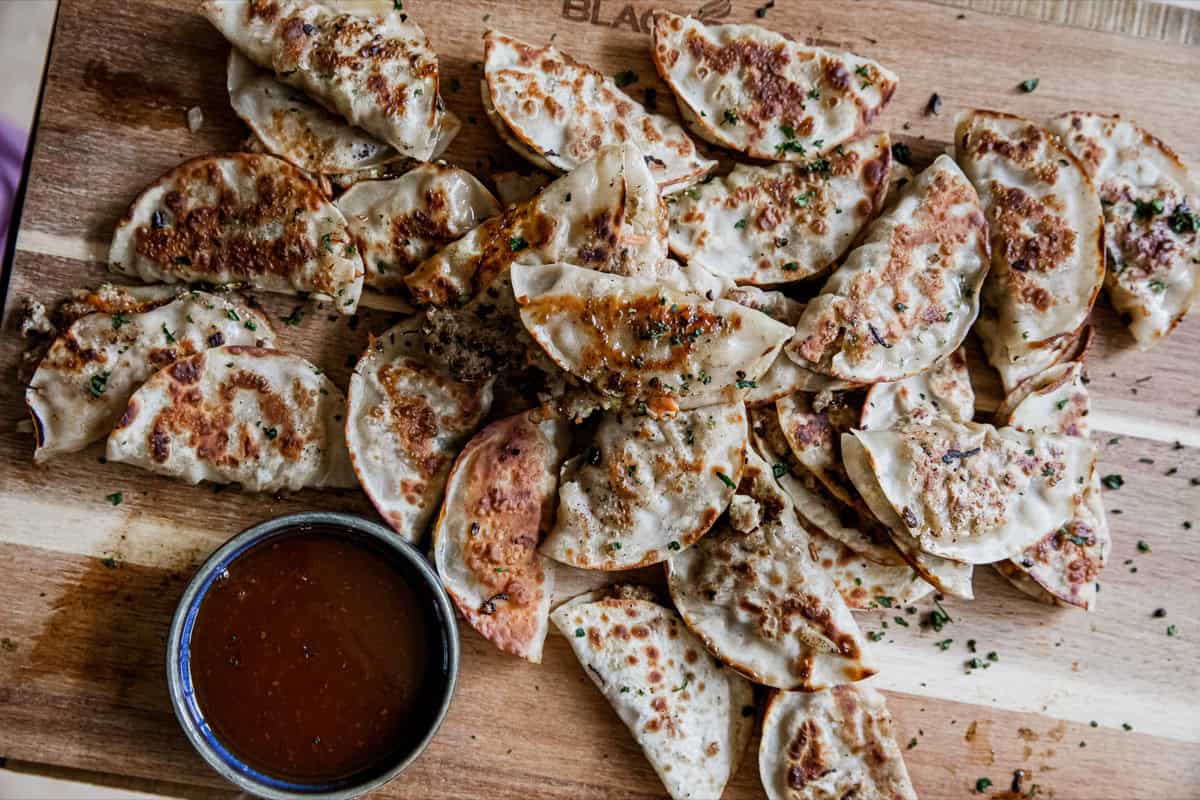 Crispy lumpia rolls cooked on a griddle.