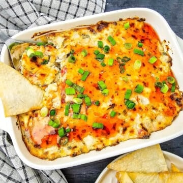 Crab Rangoon dip baked until golden and topped with sweet chili sauce and green onions, served with wonton chips.