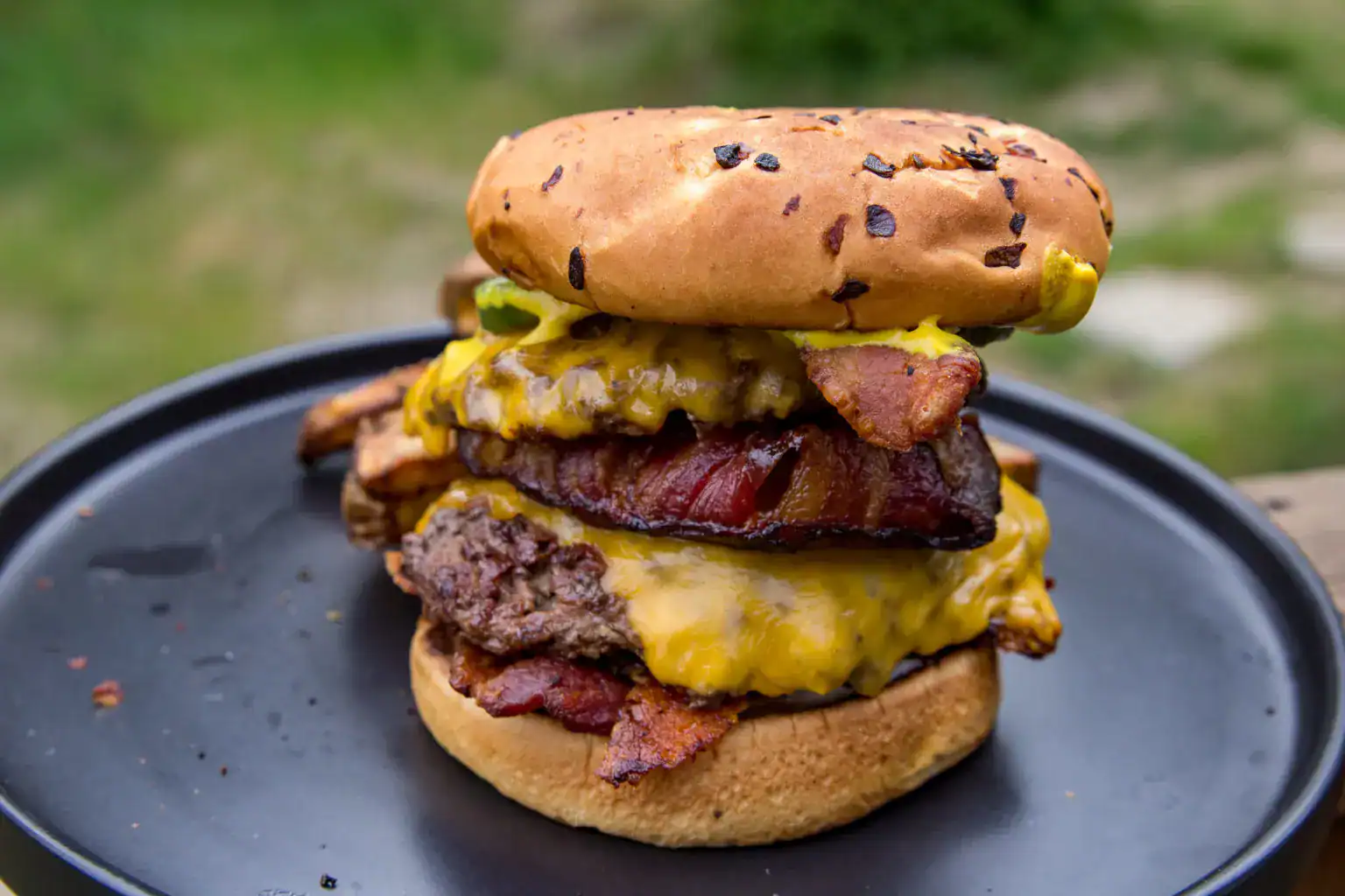 Smash-style burger with crispy bacon and caramelized onions.
