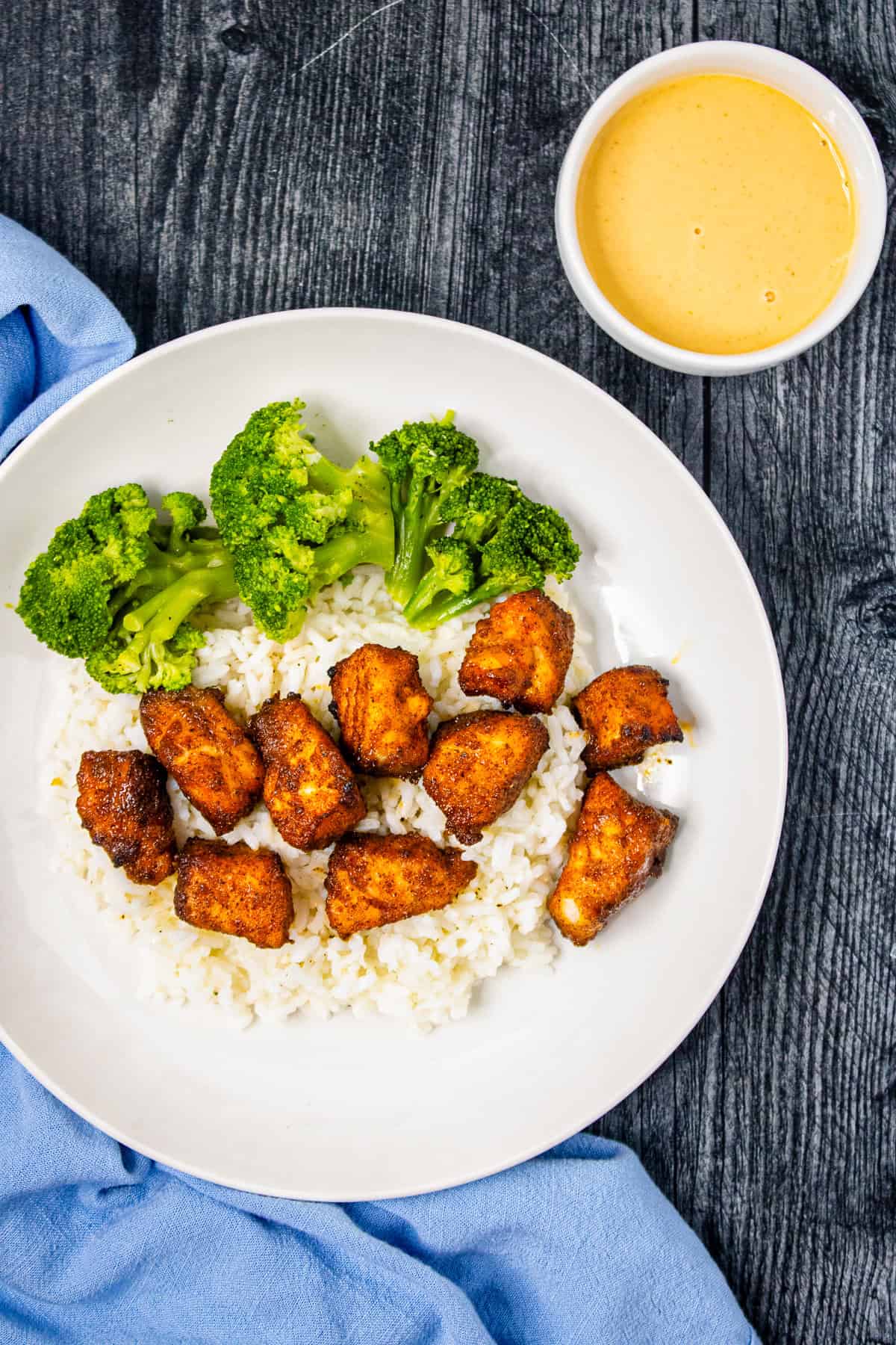Crispy air fryer salmon bites over white rice with steamed broccoli.