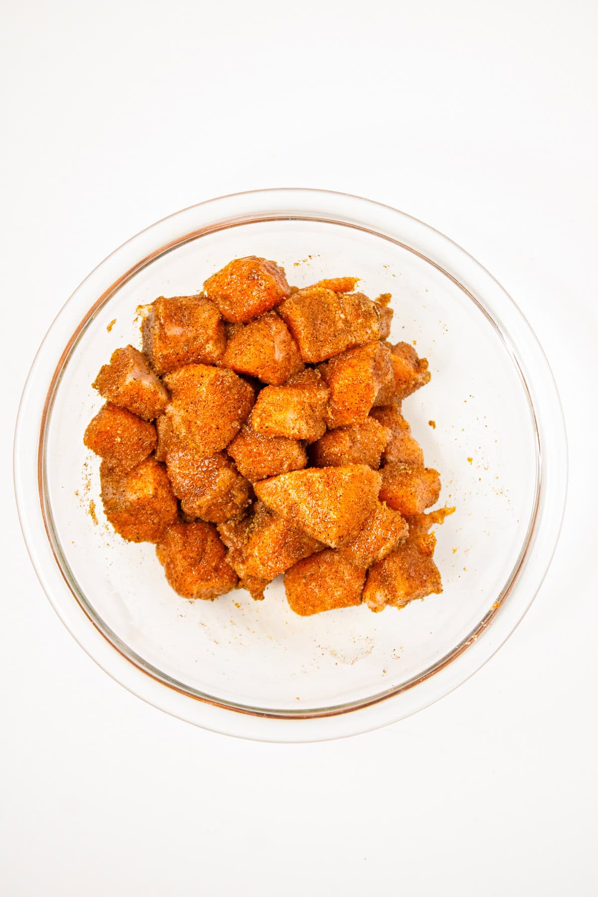 Fresh salmon cubes evenly coated with spices and seasoning for air fryer salmon bites.