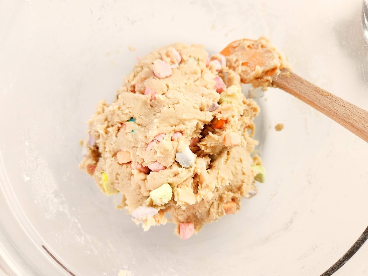 Lucky Charms cookie dough mixed with colorful marshmallow pieces.