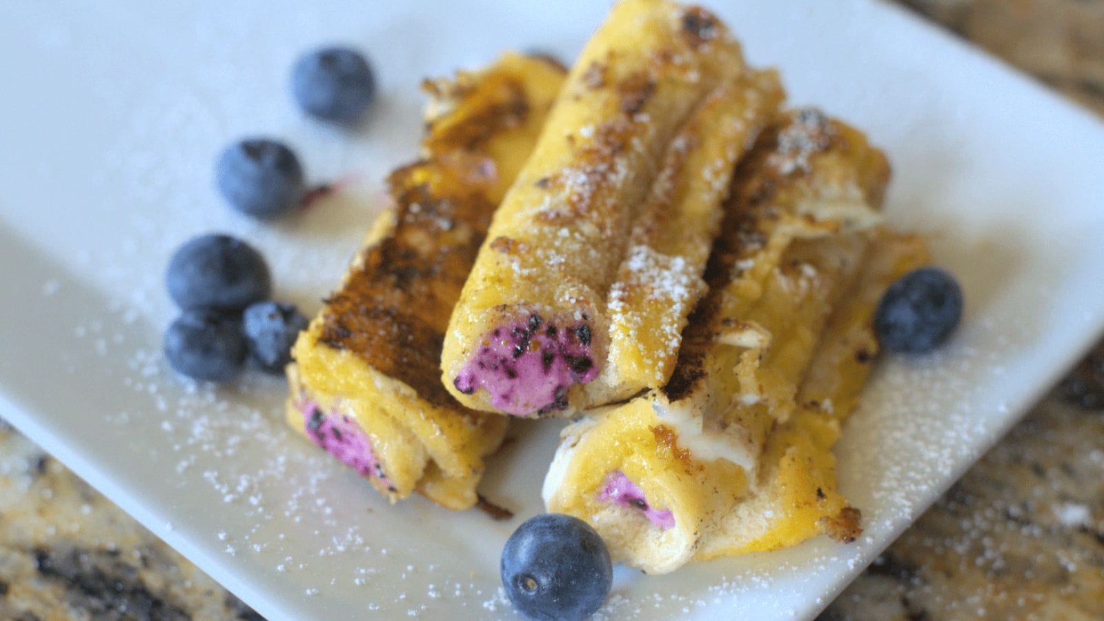 Blueberry cream cheese roll ups with sweet filling wrapped in golden pastry.