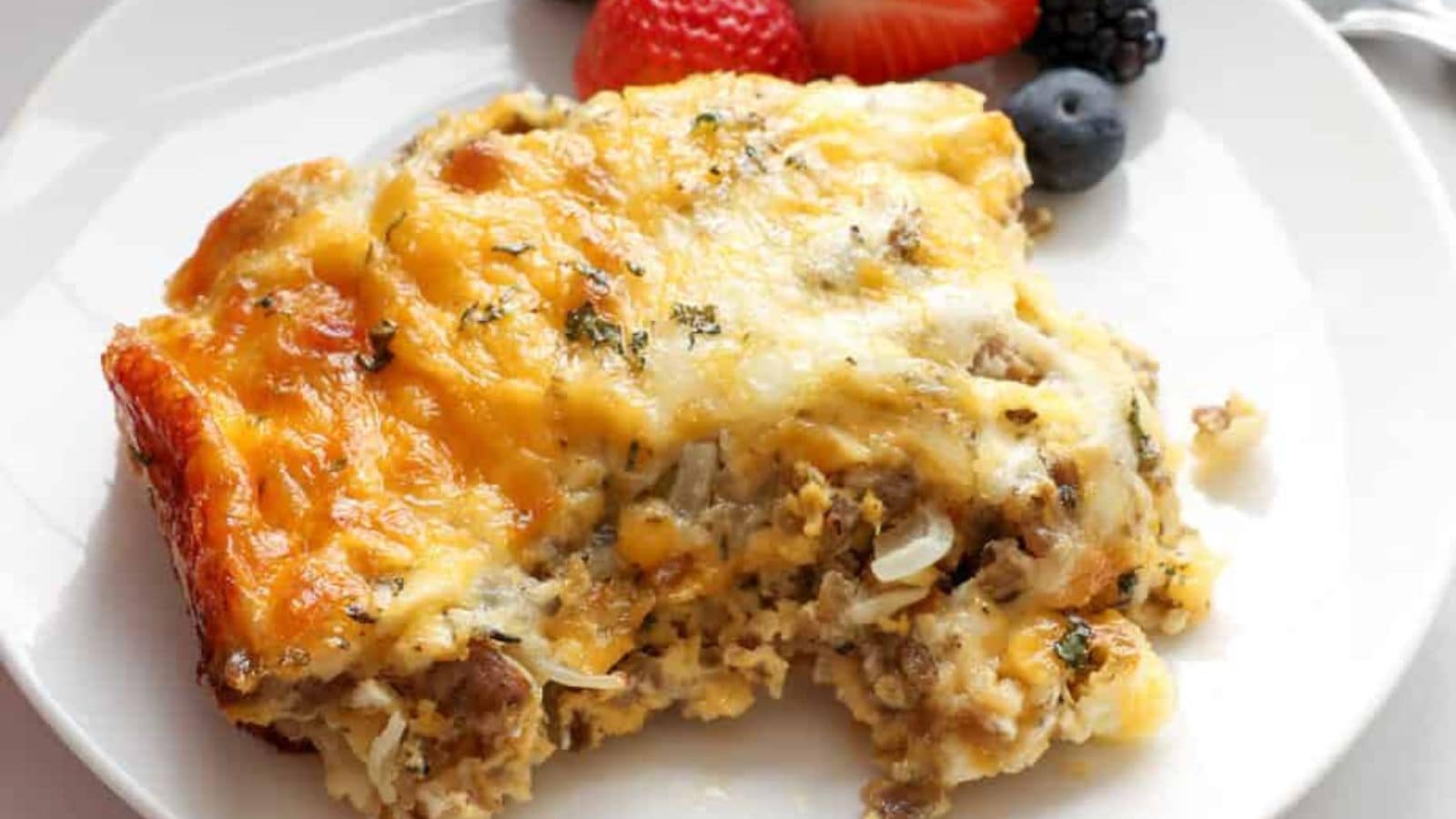 Crescent roll breakfast casserole layered with sausage, eggs, and melted cheese on flaky dough.