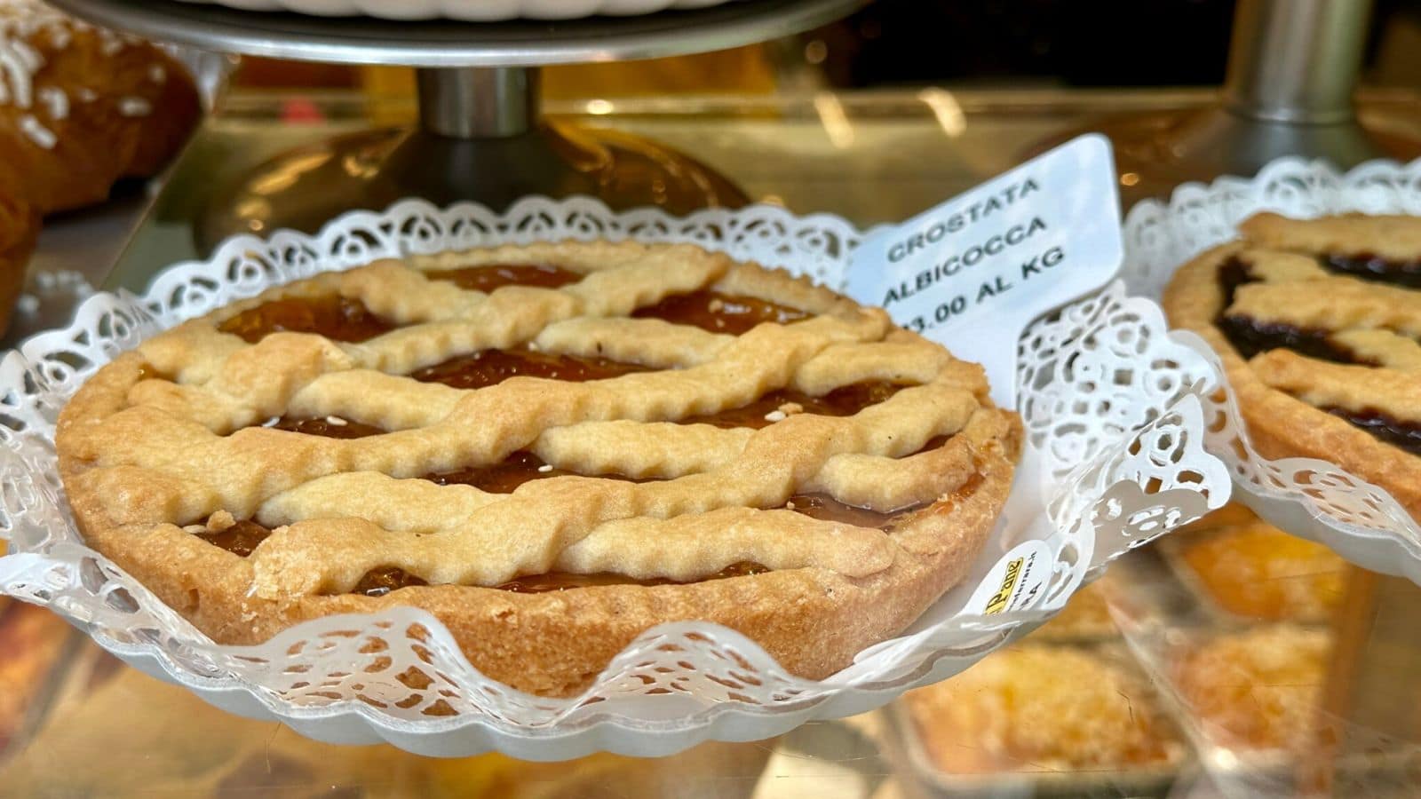 Rustic crostata tart with fruit filling baked in a golden, folded pastry crust.