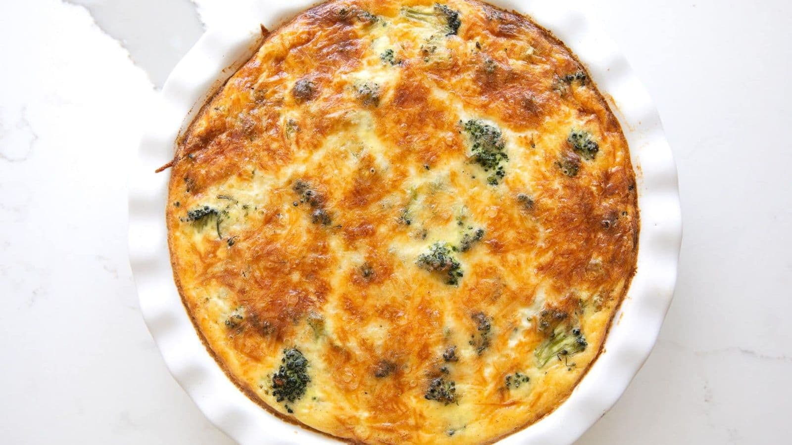 Crustless quiche filled with eggs, cheese, and savory vegetables baked until set.