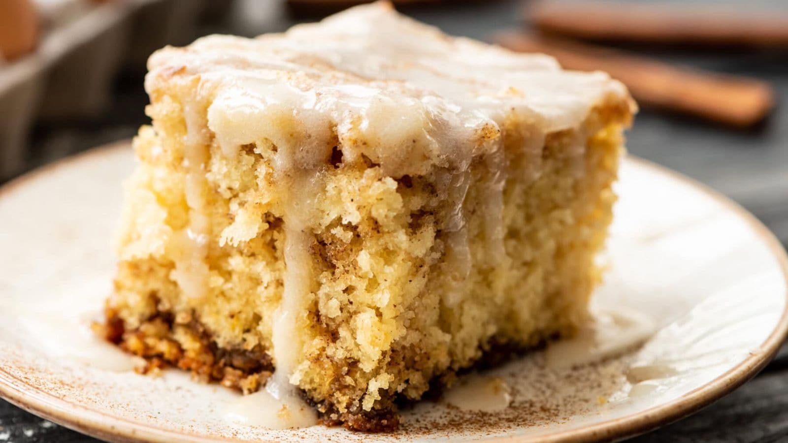 Cinnamon roll cake with swirls of cinnamon sugar and a sweet glaze drizzle.