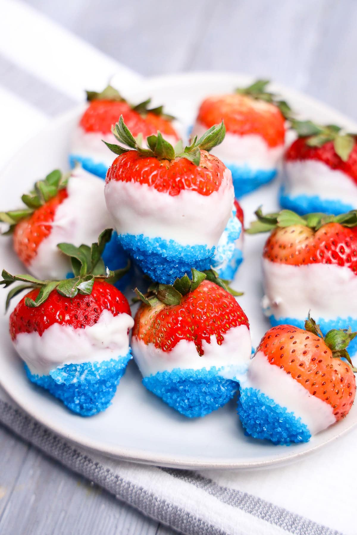 Close up of white chocolate covered strawberries with red white and blue layers.