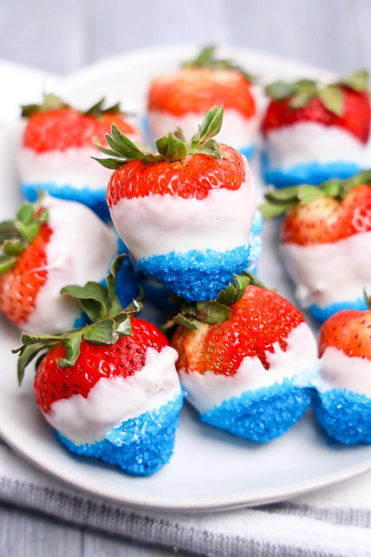 Fourth of July strawberries dipped in white chocolate and blue sugar crystals.