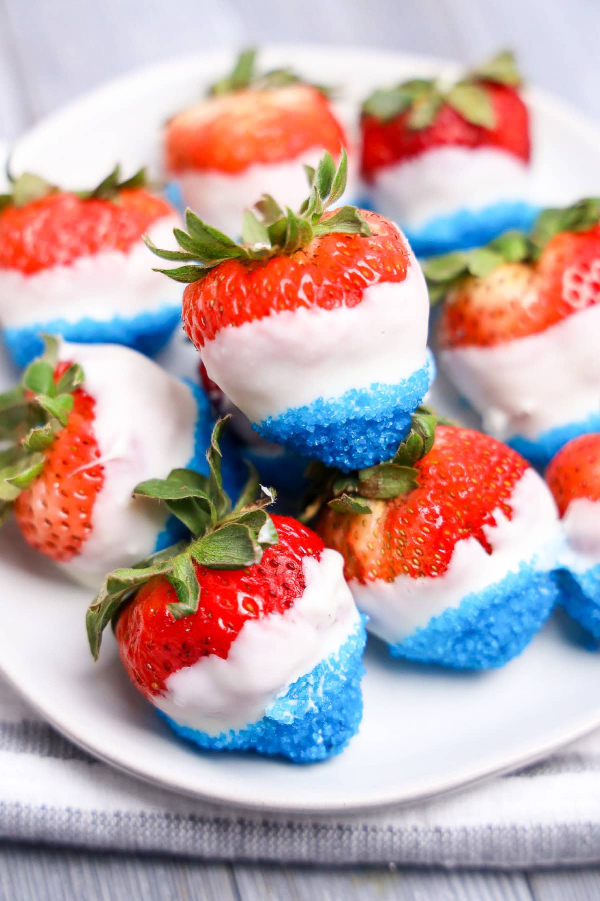 Easy July 4th dessert strawberries with white chocolate and blue sugar coating.