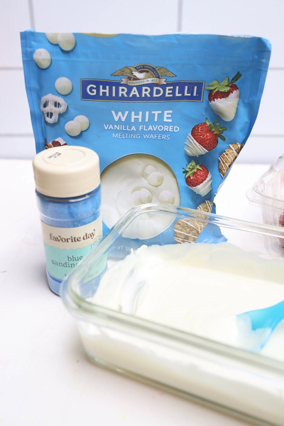 White chocolate melting wafers, blue sanding sugar, and strawberries for July 4th chocolate-covered strawberries.