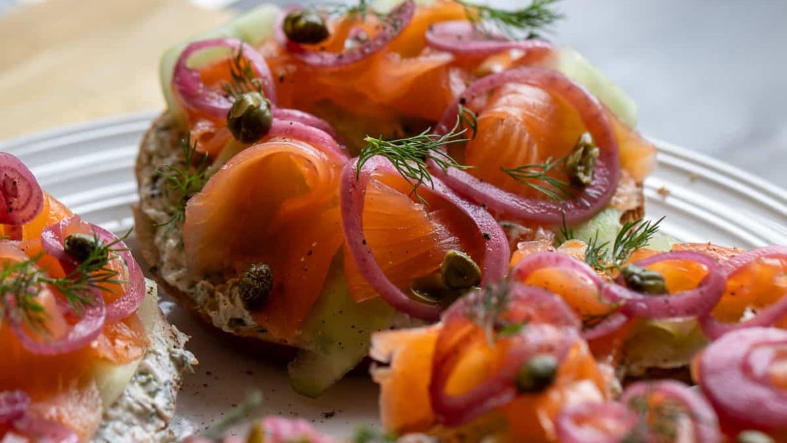 Lox bagel layered with smoked salmon, cream cheese, and fresh toppings.