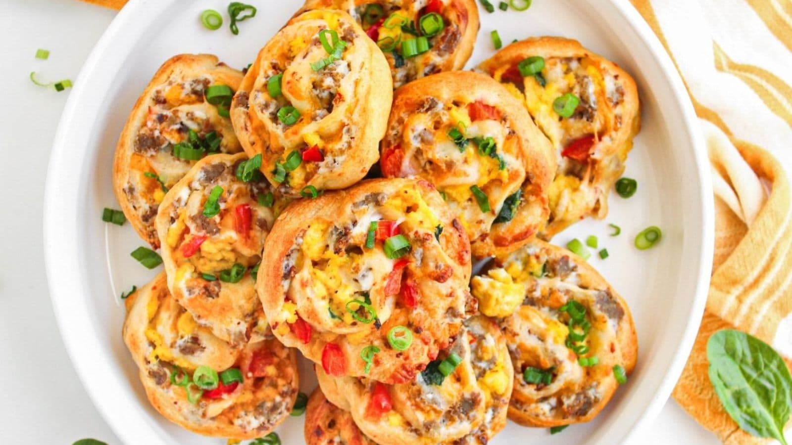 Sausage egg and cheese breakfast pinwheels baked golden with flaky layers and savory filling.