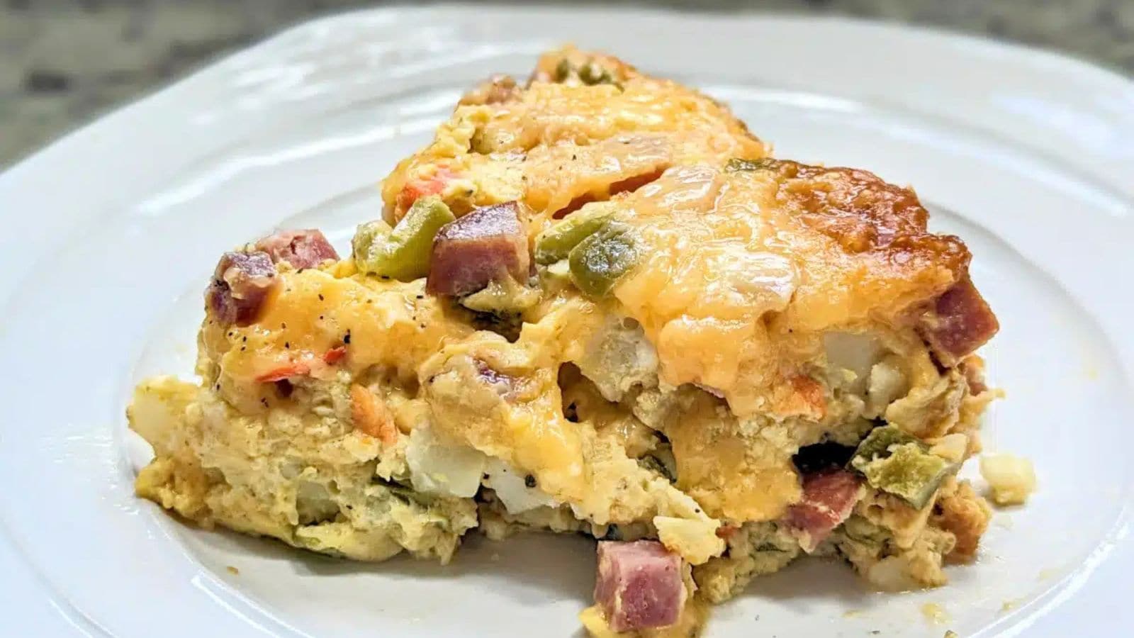 Slow cooker Denver omelet casserole with eggs, ham, peppers, and melted cheese.