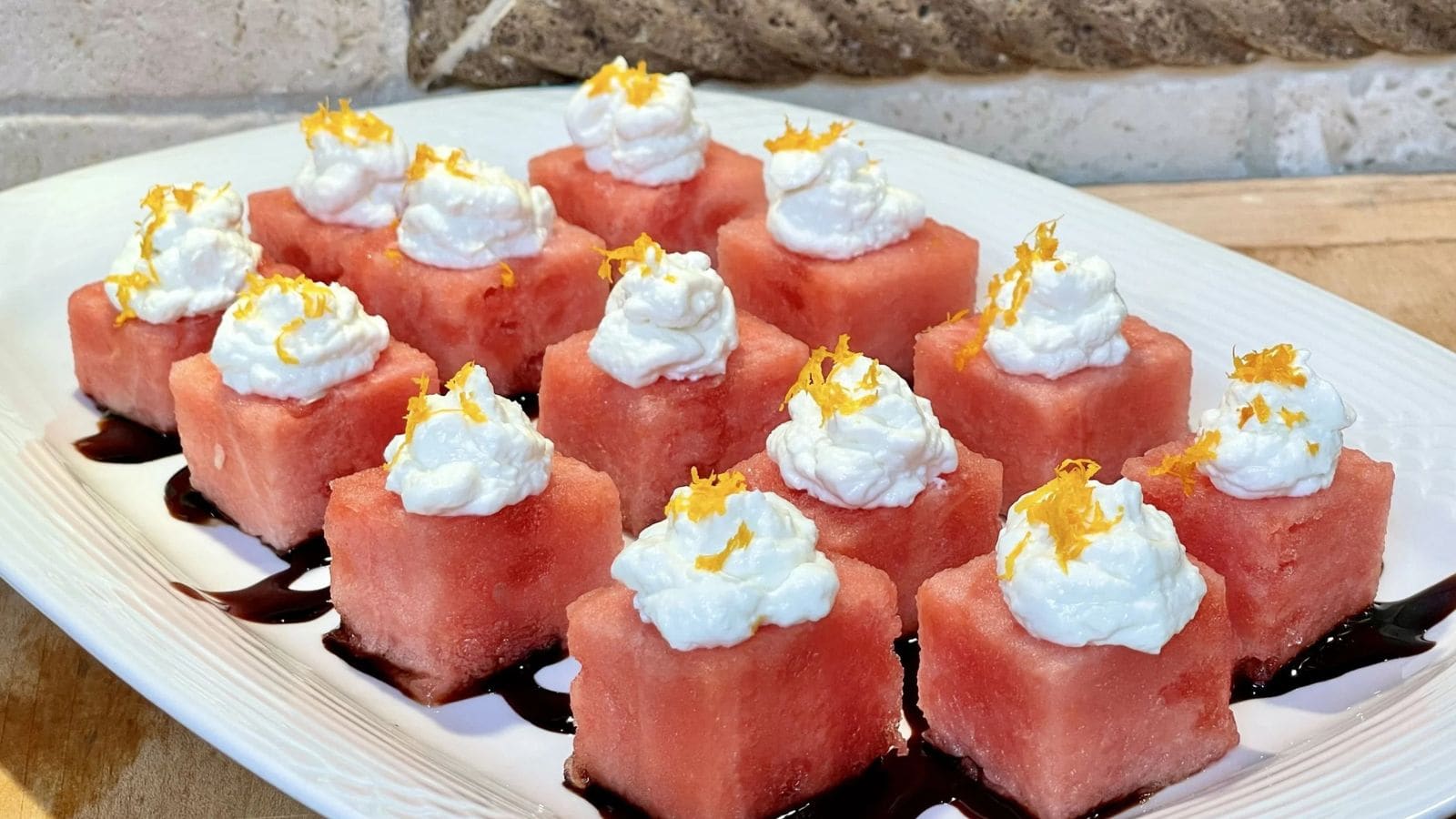Watermelon feta appetizer bites stacked with fresh fruit and salty cheese cubes.
