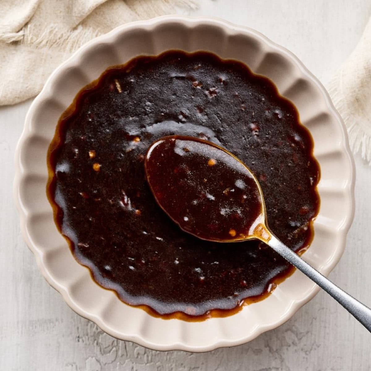 Thick hoisin sauce in a bowl with a spoon.