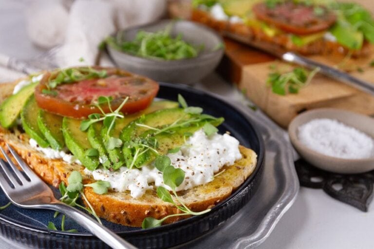 Toast with cottage cheese and avocado topping.