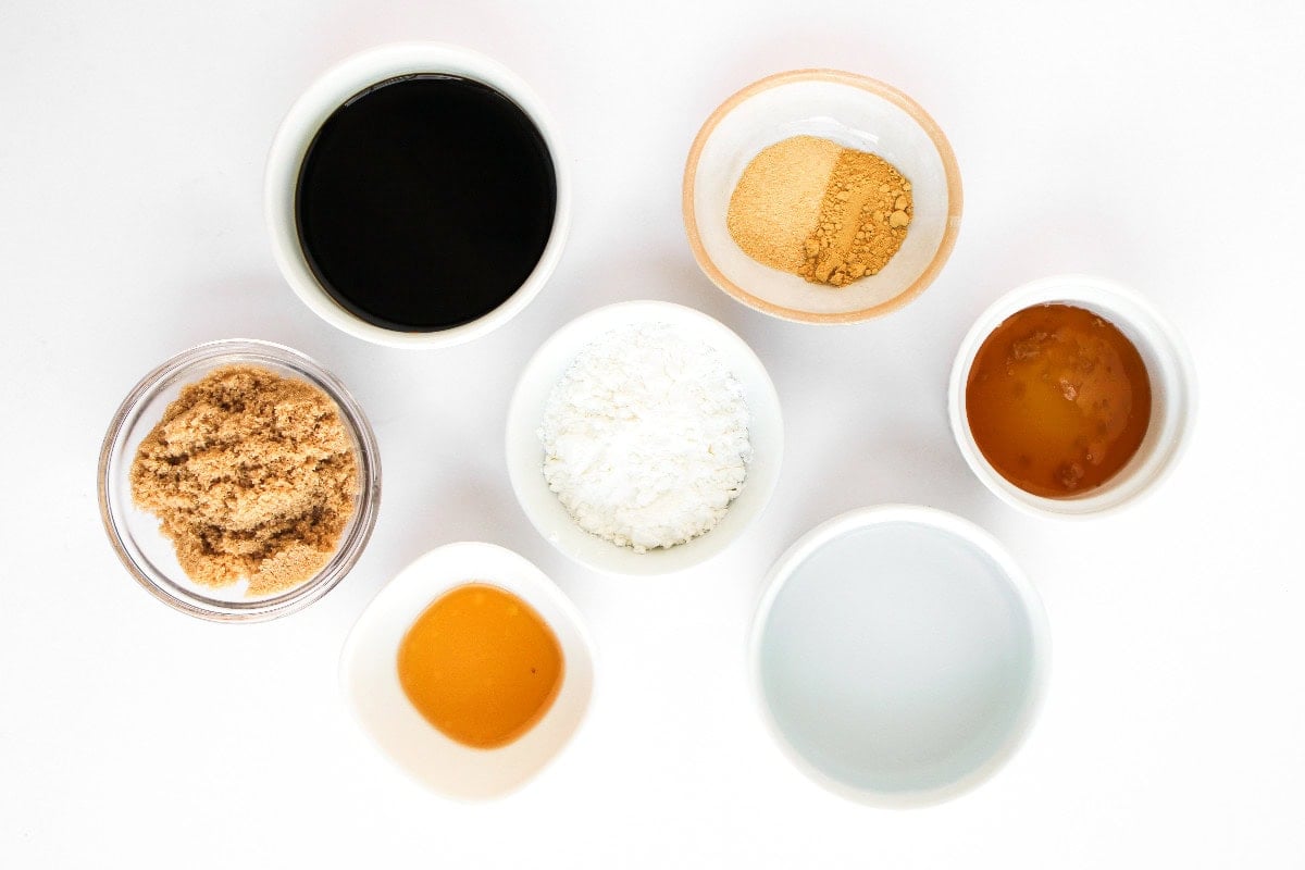 Teriyaki sauce ingredients including soy sauce, sugar, and cornstarch in small bowls.